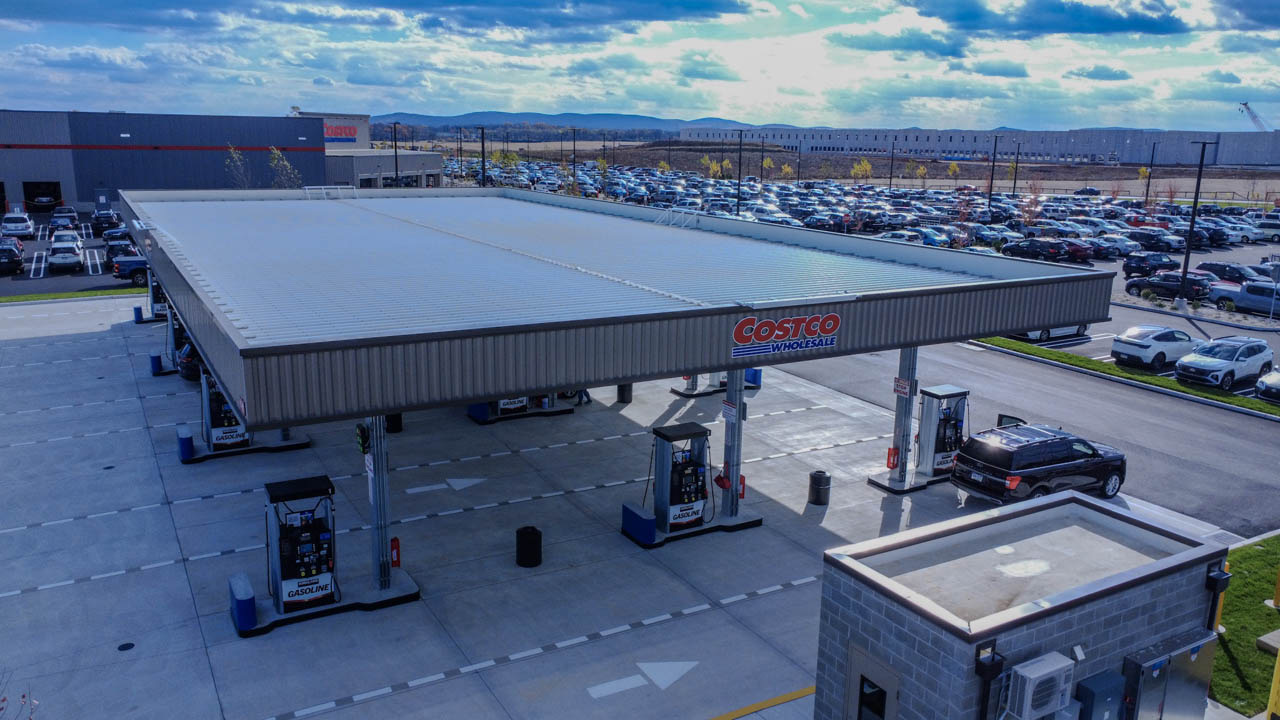 Drone shot of the Costco fuel station canopy under a dramatic sky