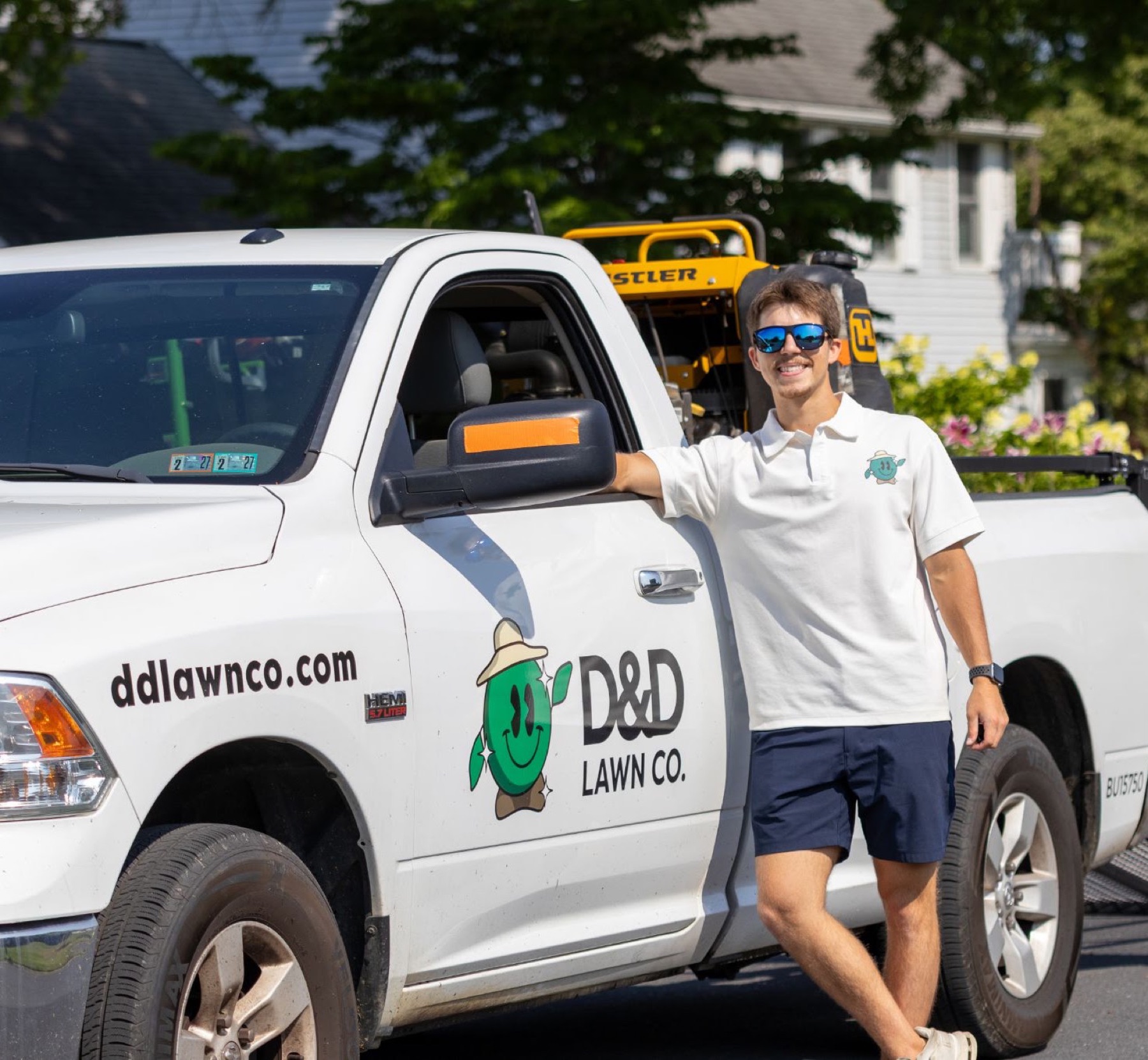 D&D Landscaping owner beside the branded company truck