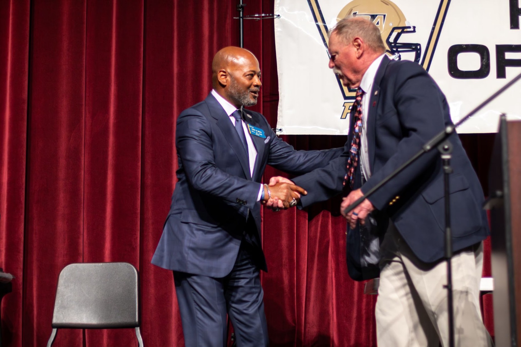 Award handshake on stage