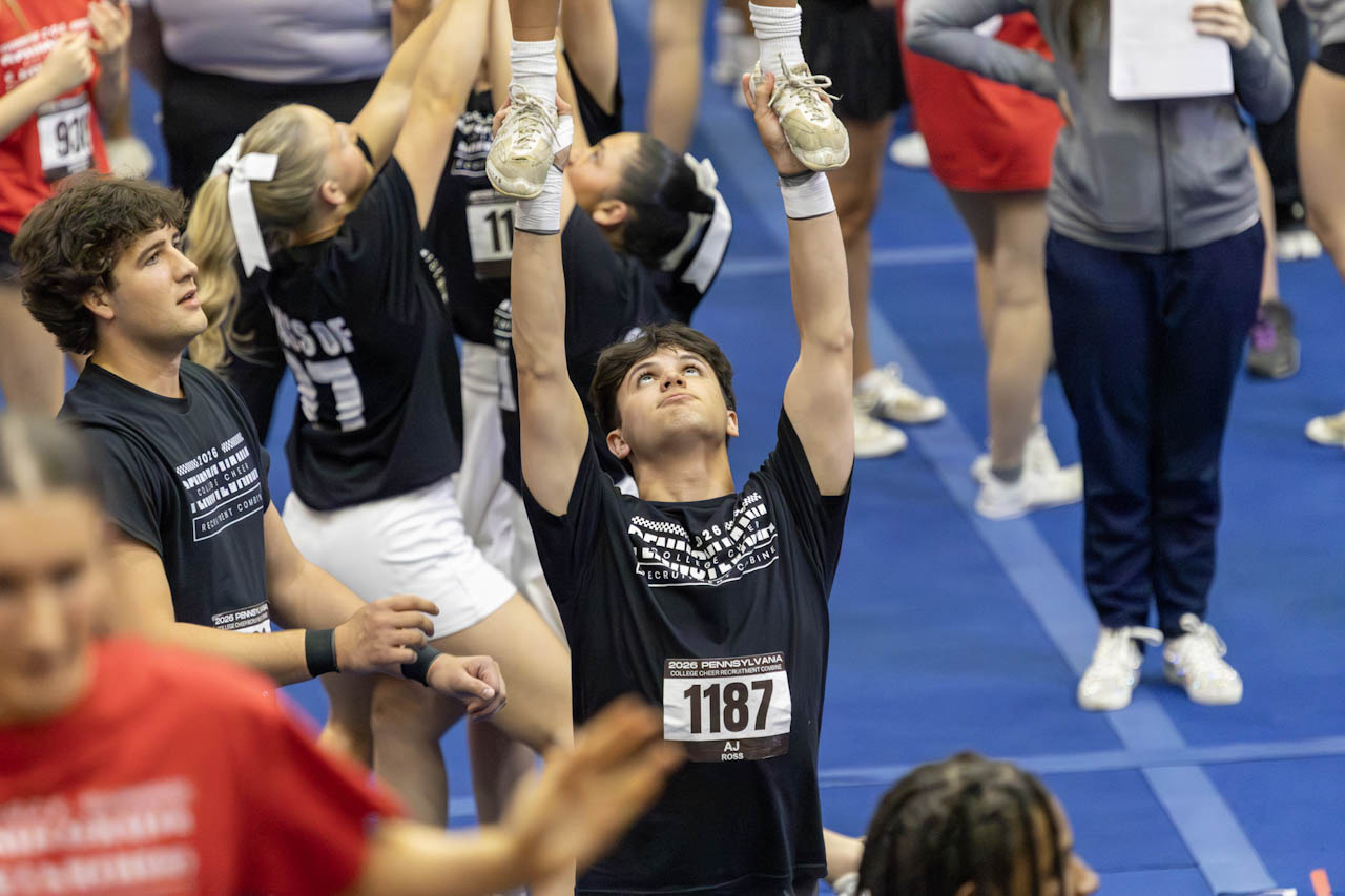 Cheer stunt at a packed gym event
