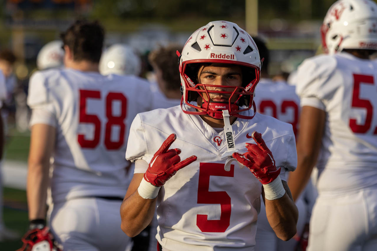 Football player number 5 celebrating with teammates