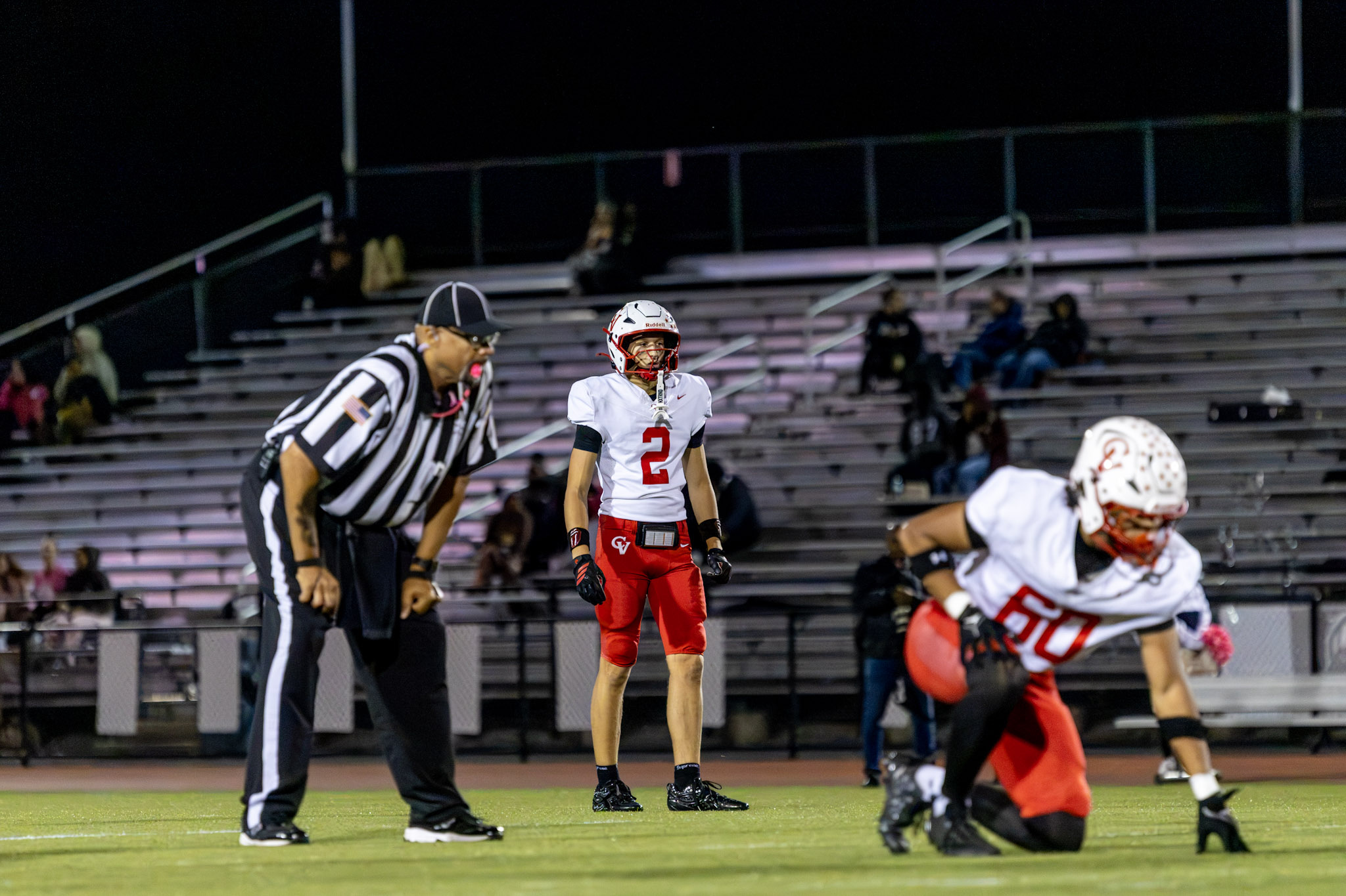 Football player and referee at a night game