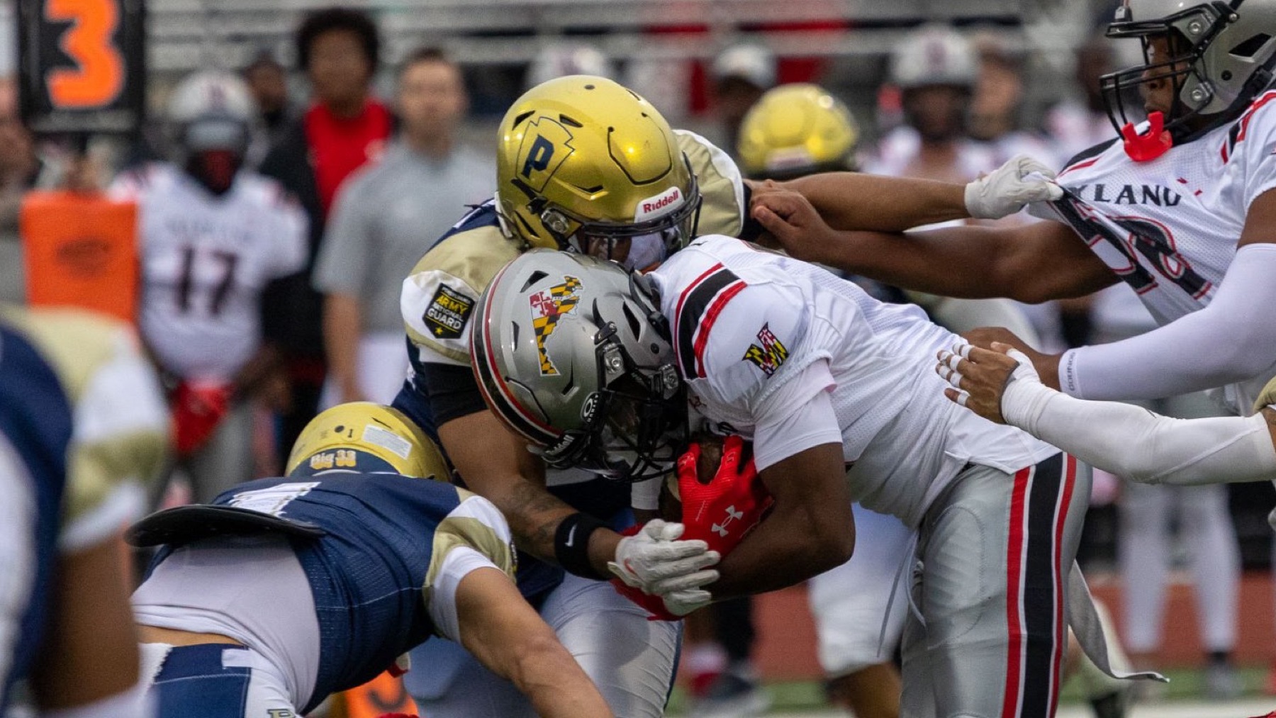 Football players colliding at the line of scrimmage