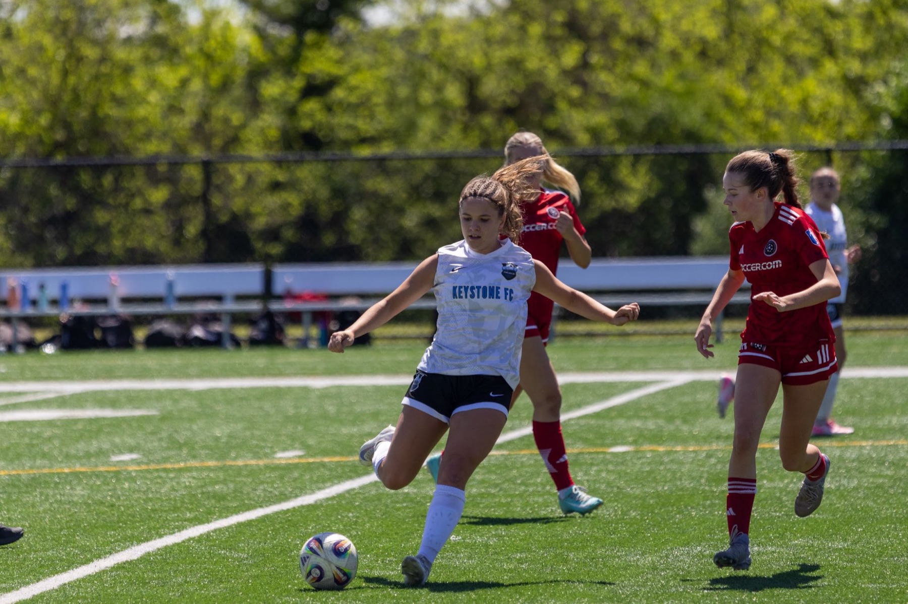 Soccer players racing for the ball
